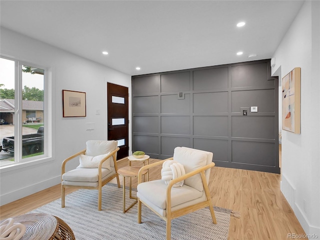 7126 Joan St, Denver, CO 80221 - living area featuring a decorative wall, recessed lighting, light wood finished floors, and baseboards