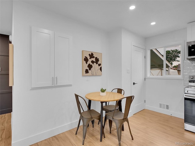 7126 Joan St, Denver, CO 80221 - dining space with baseboards, light wood finished floors, and recessed lighting