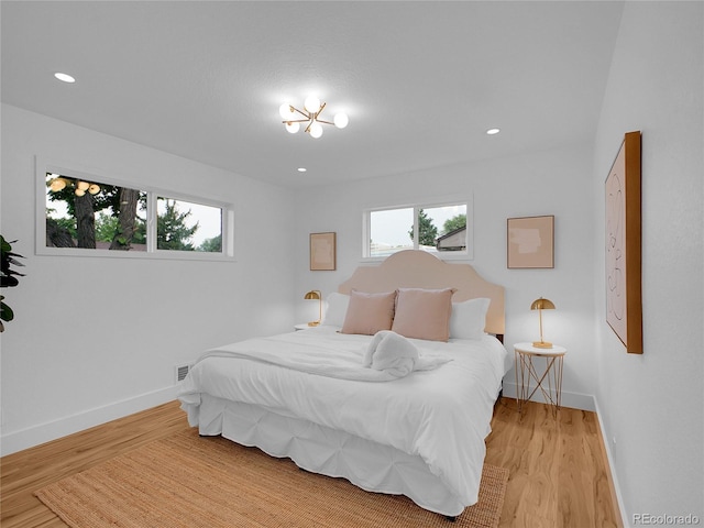 7126 Joan St, Denver, CO 80221 - bedroom featuring multiple windows, light wood-style flooring, baseboards, and recessed lighting