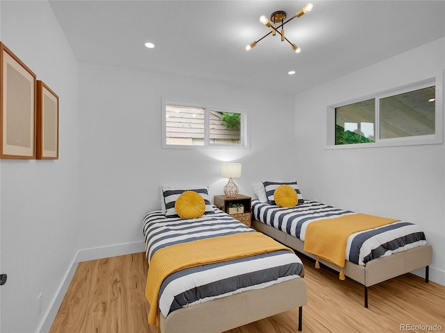 7126 Joan St, Denver, CO 80221 - bedroom featuring baseboards, multiple windows, light wood-type flooring, a chandelier, and recessed lighting