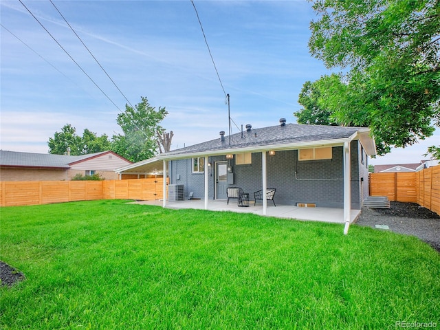7126 Joan St, Denver, CO 80221 - rear view of house with a patio area, brick siding, and central AC unit