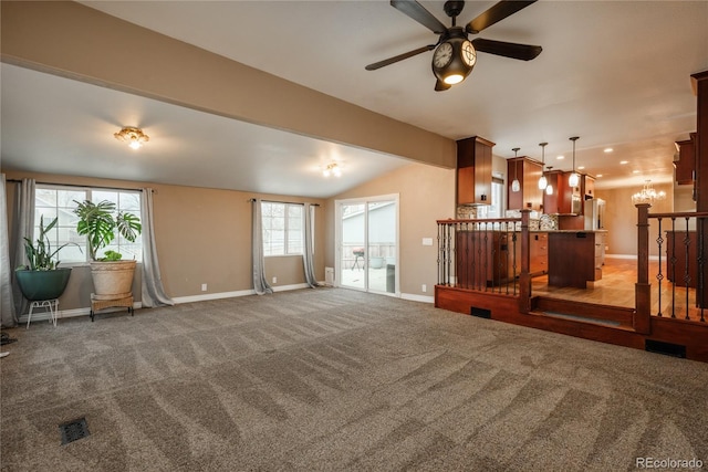 unfurnished living room with lofted ceiling, recessed lighting, carpet, and baseboards