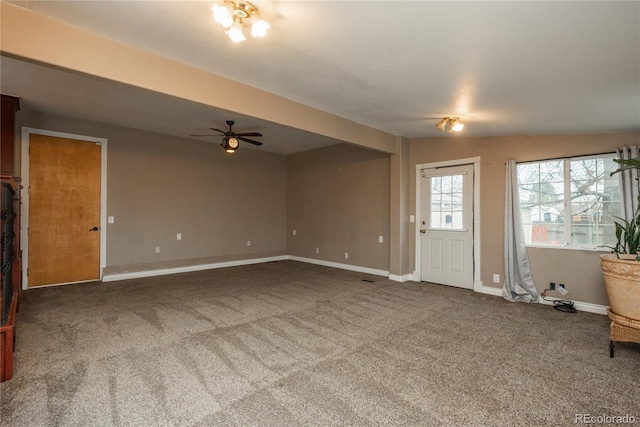 unfurnished living room with carpet flooring, baseboards, lofted ceiling, and a ceiling fan