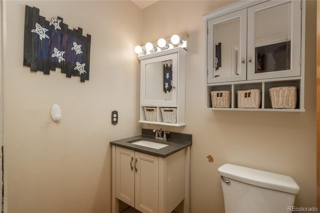 bathroom featuring toilet and vanity