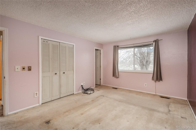 unfurnished bedroom with visible vents, baseboards, and carpet floors