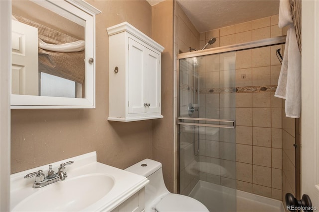 full bathroom with a stall shower, toilet, and vanity