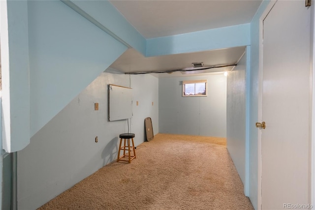 basement featuring carpet flooring and visible vents