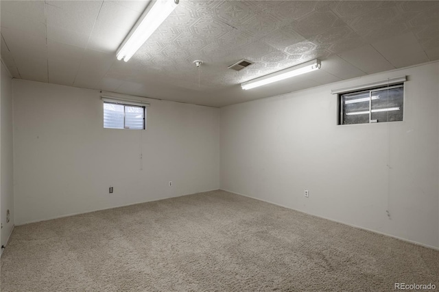 basement with visible vents and carpet