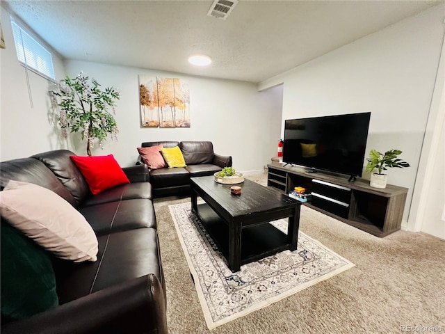 living area featuring carpet flooring and visible vents