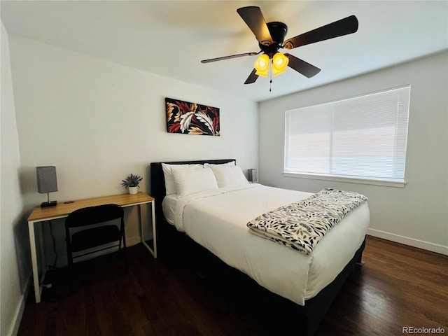 bedroom with ceiling fan, baseboards, and dark wood-style flooring