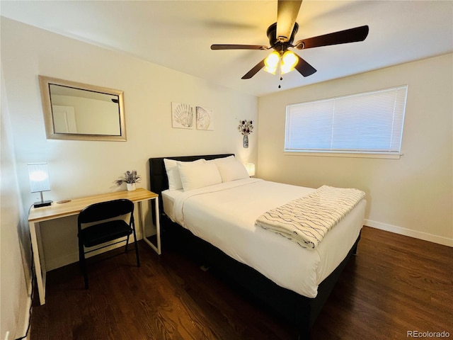 bedroom with ceiling fan, dark wood-type flooring, and baseboards