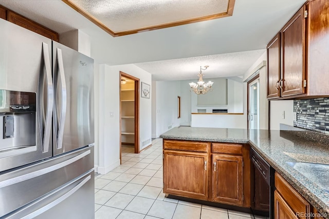 kitchen with light tile patterned floors, dishwasher, a peninsula, a textured ceiling, and stainless steel refrigerator with ice dispenser