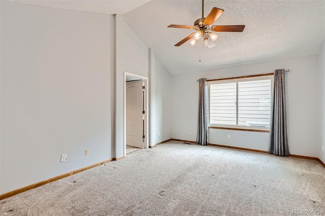 carpeted spare room with vaulted ceiling, ceiling fan, a textured ceiling, and baseboards