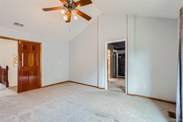 unfurnished bedroom featuring lofted ceiling, carpet flooring, visible vents, and baseboards