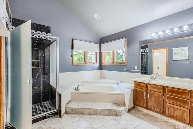 full bathroom with a stall shower, lofted ceiling, a garden tub, and vanity