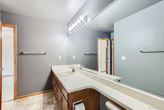 bathroom featuring baseboards and vanity