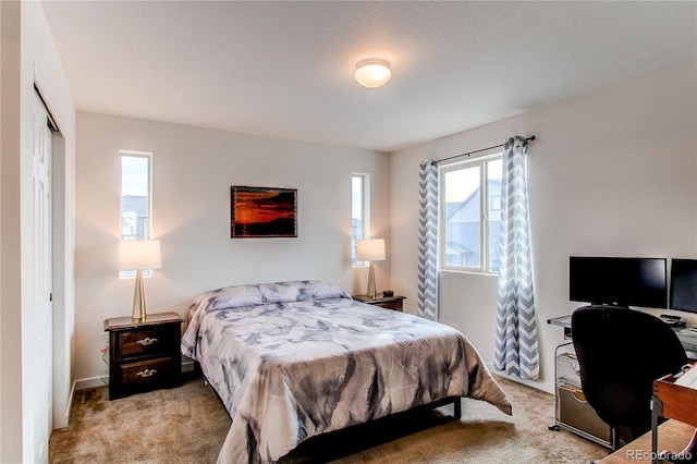 bedroom featuring light carpet and a closet