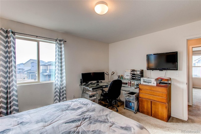 carpeted bedroom featuring multiple windows