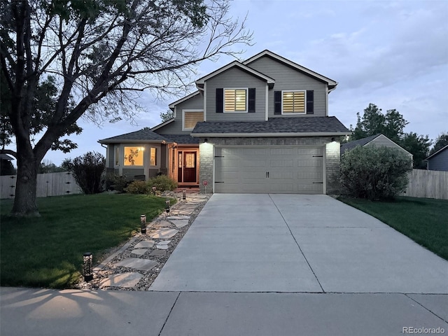 traditional-style house featuring concrete driveway and a garage