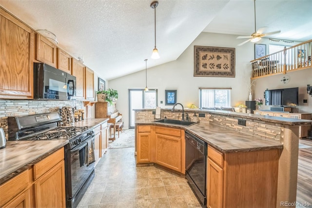 kitchen featuring black appliances, a sink, backsplash, plenty of natural light, and high vaulted ceiling