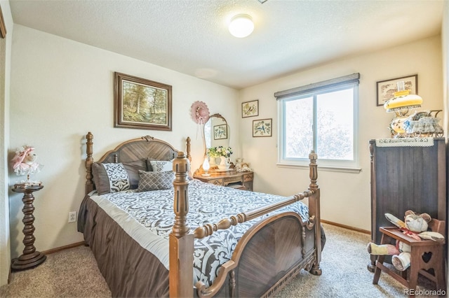 carpeted bedroom featuring baseboards and a textured ceiling