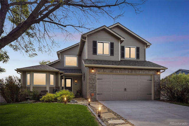 traditional home with an attached garage, driveway, a front lawn, and roof with shingles