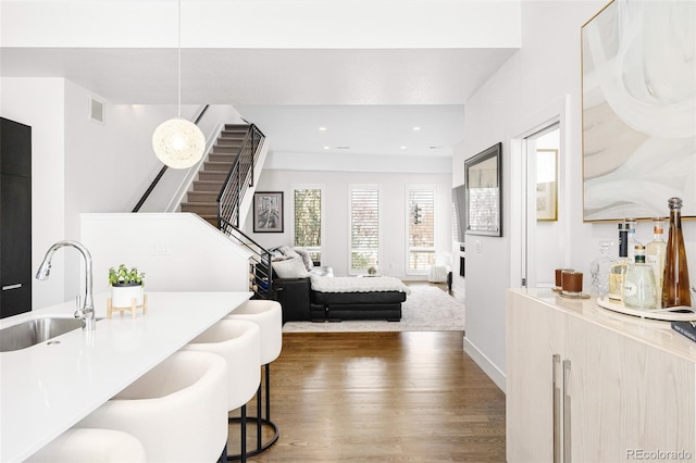 bedroom with a sink, recessed lighting, baseboards, visible vents, and dark wood-style floors