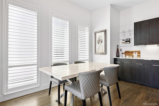 dining area featuring dark wood-type flooring