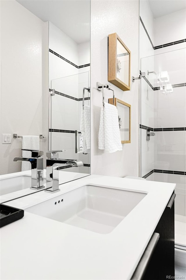 full bath featuring vanity, walk in shower, and toilet