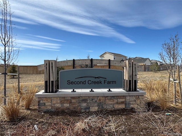 community / neighborhood sign with fence