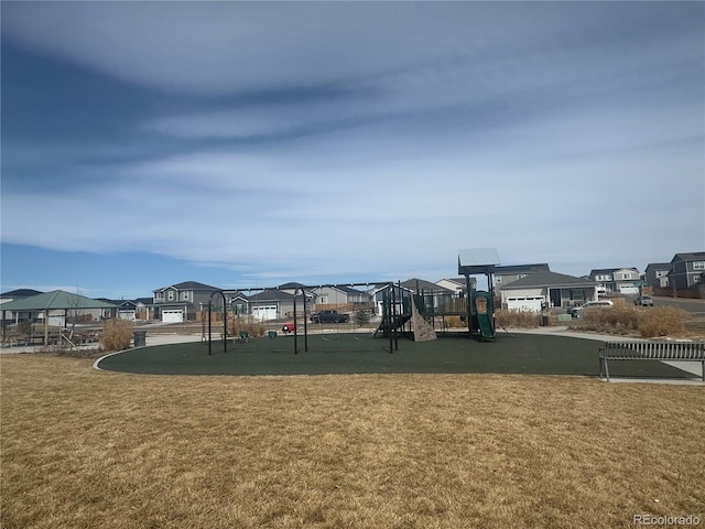 community playground featuring a residential view and a lawn