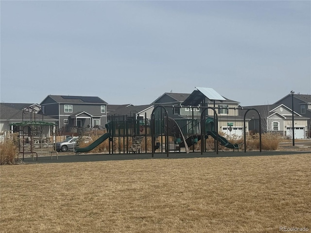 communal playground with a lawn and a residential view