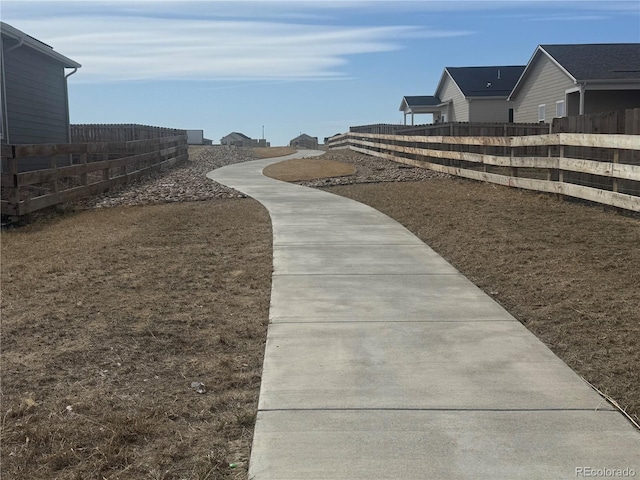 view of home's community with fence