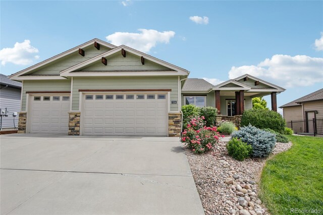 7258 Spanish Bay Dr, Windsor, CO 80550 - craftsman-style home with stone siding, concrete driveway, and an attached garage