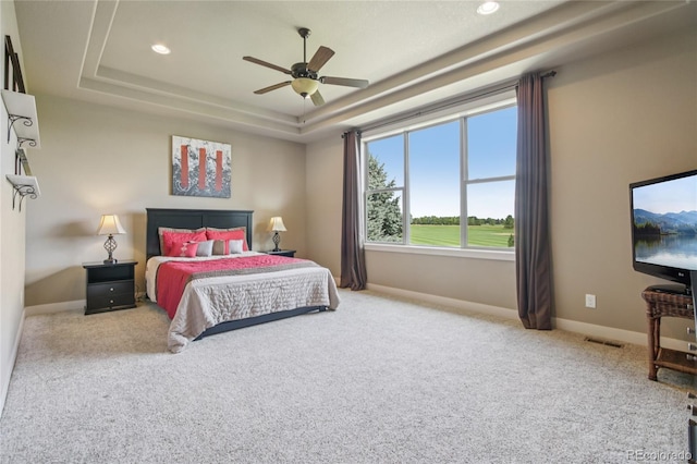 7258 Spanish Bay Dr, Windsor, CO 80550 - carpeted bedroom with a tray ceiling, recessed lighting, and ceiling fan