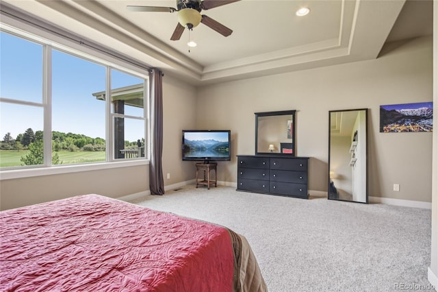 7258 Spanish Bay Dr, Windsor, CO 80550 - carpeted bedroom with a tray ceiling, recessed lighting, and a ceiling fan