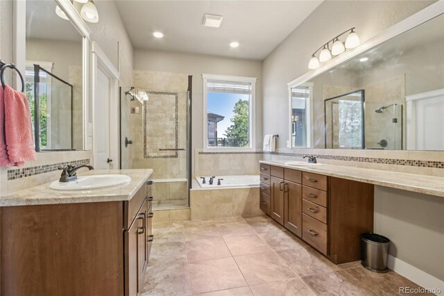 7258 Spanish Bay Dr, Windsor, CO 80550 - bathroom featuring two vanities, a shower stall, a garden tub, and recessed lighting
