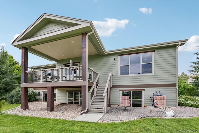 7258 Spanish Bay Dr, Windsor, CO 80550 - rear view of house with a patio area, a wooden deck, stairs, and a lawn