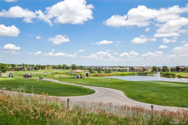 7258 Spanish Bay Dr, Windsor, CO 80550 - view of property's community with a water view, a yard, and view of golf course
