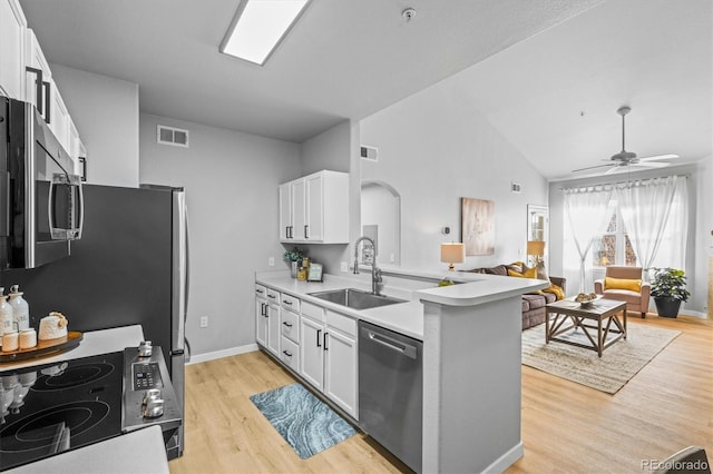 10805 Twenty Mile Rd Unit 307, Parker, CO 80134 - kitchen featuring stainless steel appliances, a peninsula, open floor plan, light wood finished floors, and white cabinets