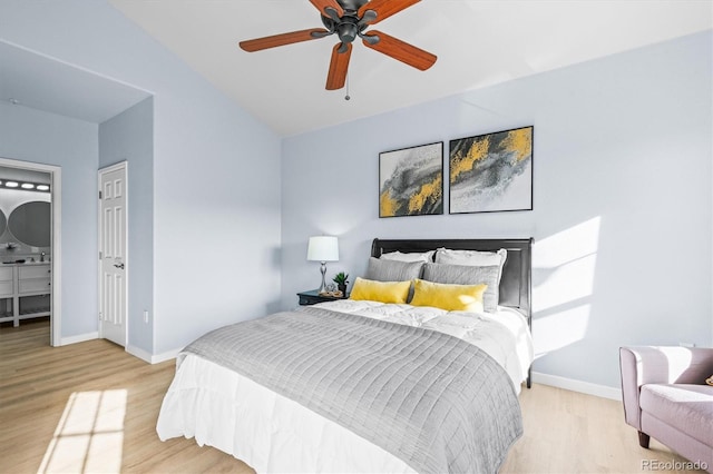 bedroom featuring ceiling fan, light hardwood / wood-style flooring, and lofted ceiling