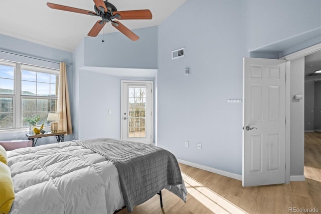 bedroom with access to exterior, light hardwood / wood-style floors, ceiling fan, and lofted ceiling