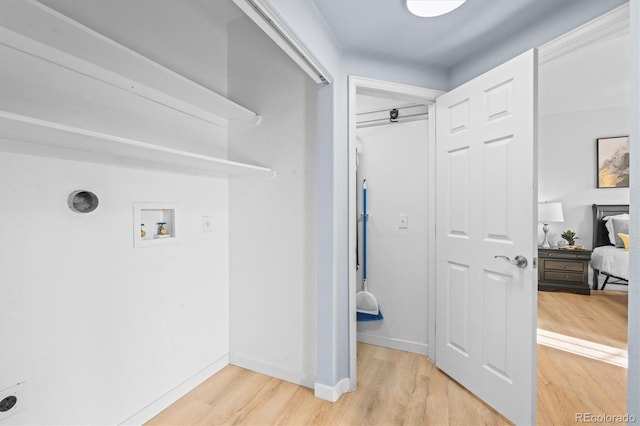 washroom with washer hookup and wood-type flooring