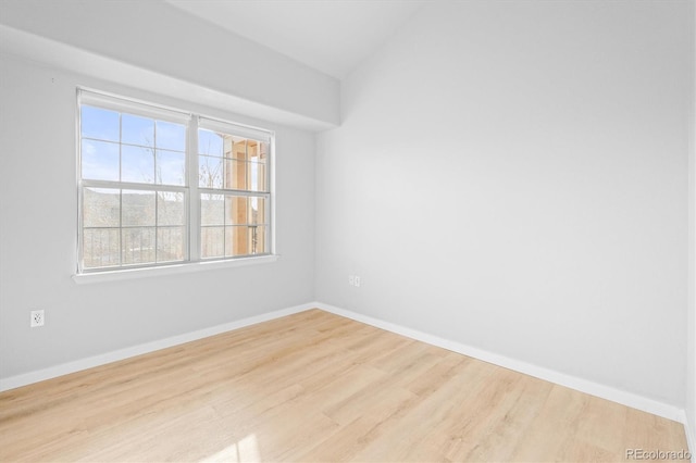 10805 Twenty Mile Rd Unit 307, Parker, CO 80134 - spare room featuring wood finished floors and vaulted ceiling