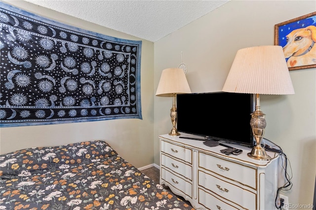 bedroom with a textured ceiling and lofted ceiling