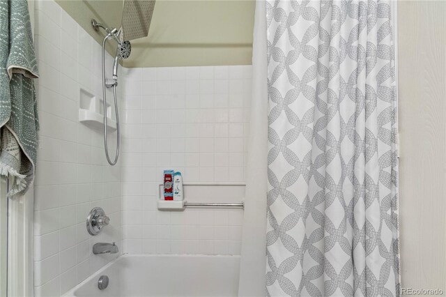 bathroom with shower / bath combination with curtain