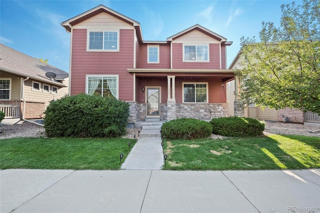 view of front of home with a front yard and stone siding