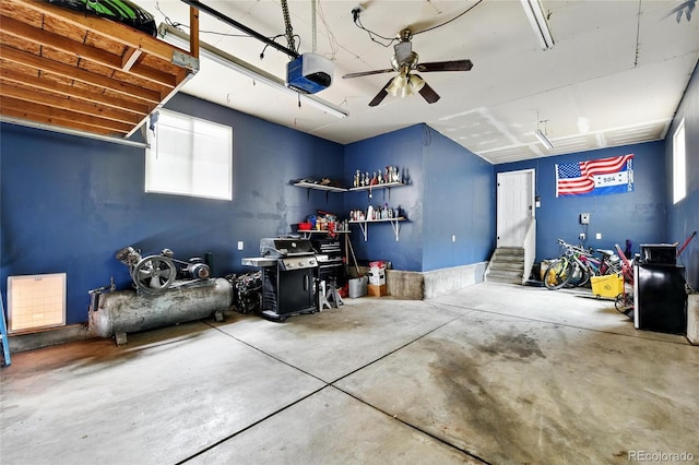 garage featuring a garage door opener and a ceiling fan