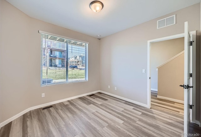 spare room with light hardwood / wood-style flooring