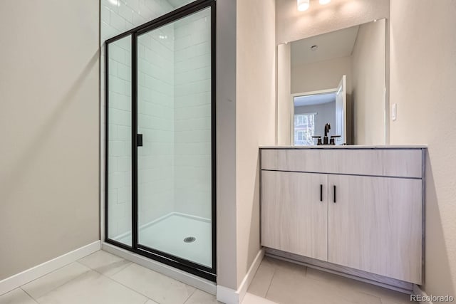 bathroom featuring vanity, tile patterned floors, and a shower with shower door